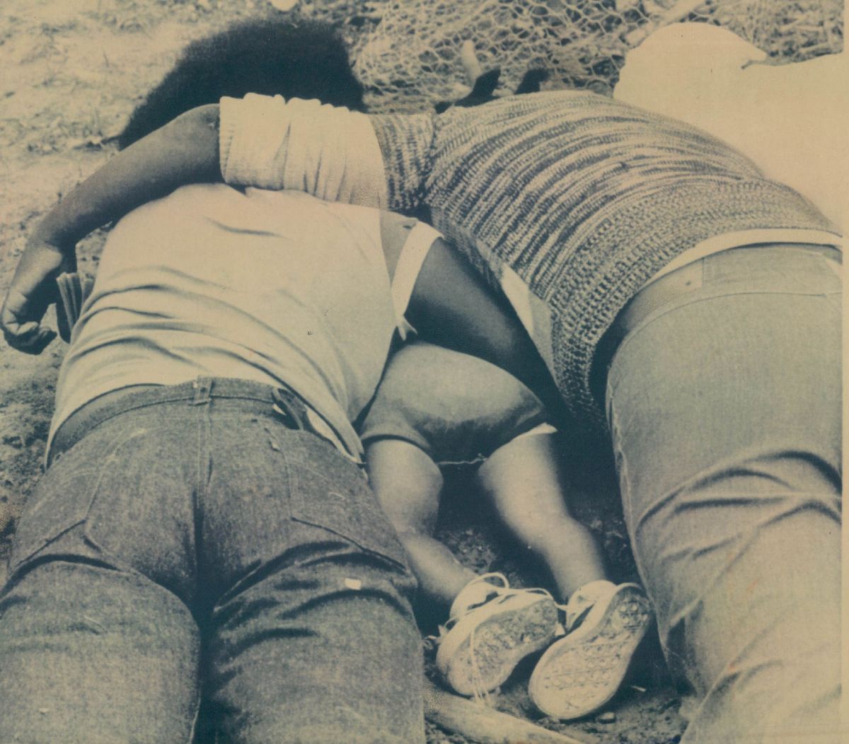 A man woman lie face down with a child between them in Jonestown, Guyana Monday following a mass suicide.