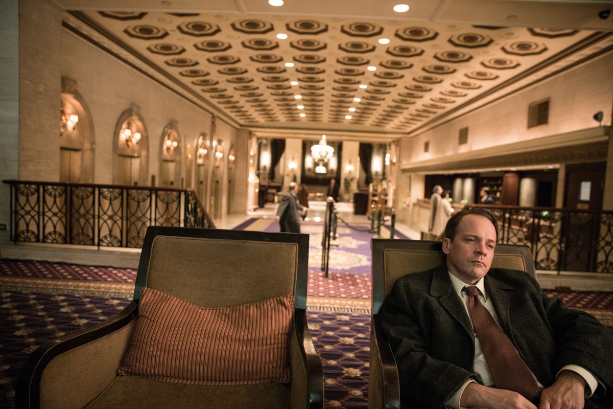 a man sits in a hotel lobby