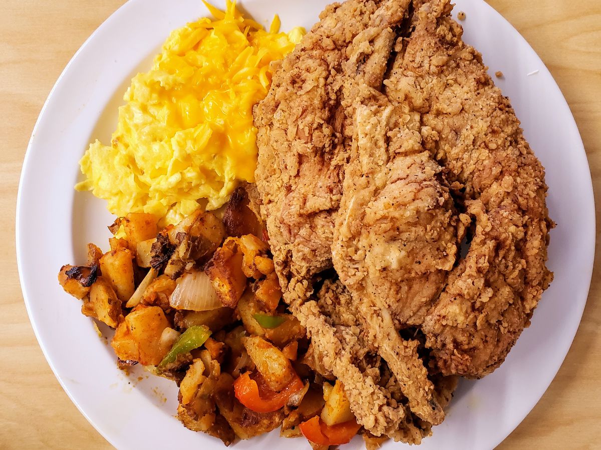 A turkey chop with scrambled eggs and hash at the Serving Spoon.