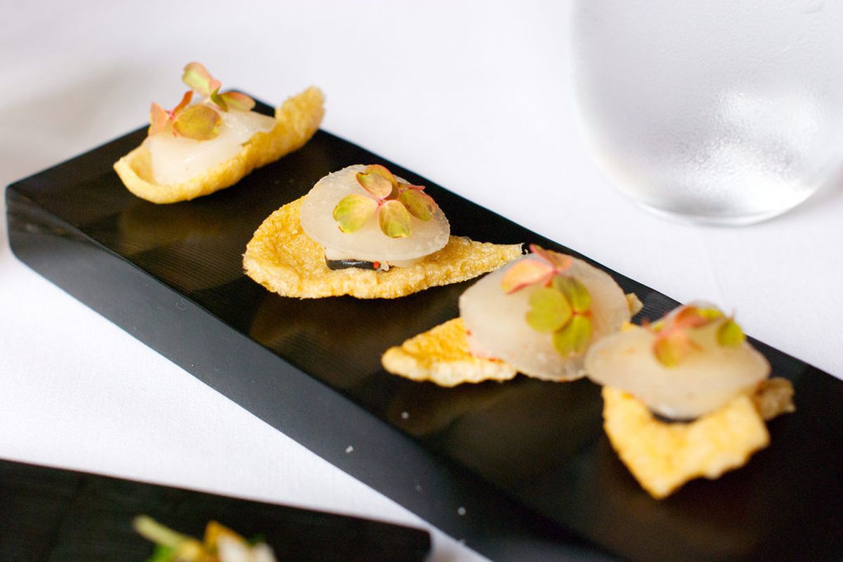 Amuse Bouche of Scallop on a Chip with Pickled Daikon and Sesame from Eleven Madison Park by <a href="http://www.flickr.com/photos/gourmetgourmand/8079531023/in/pool-eater">gourmetgourmand</a>
