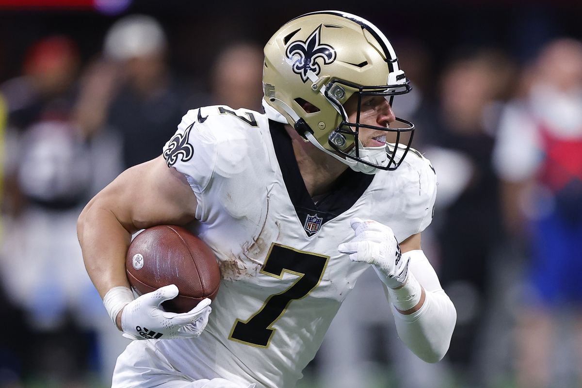 Taysom Hill #7 of the New Orleans Saints rolls out during the second half of the game against the Atlanta Falcons at Mercedes-Benz Stadium on September 11, 2022 in Atlanta, Georgia.