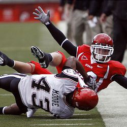 Utah senior receiver Derrek Richards tries to get out of bounds after making a catch. San Diego State's Aaron Moore makes the tackle.
