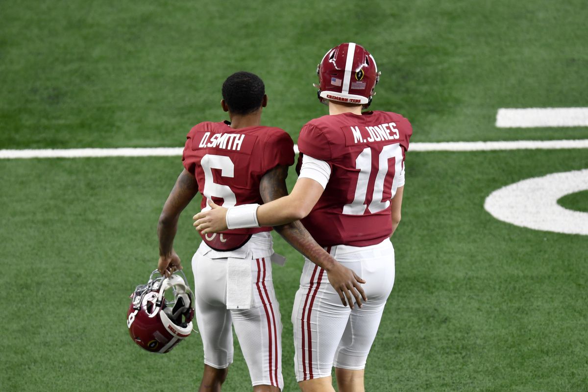 DeVonta Smith of the Alabama Crimson Tide and Mac Jones hug before the College Football Playoff Semifinal at the Rose Bowl football game against the Notre Dame Fighting Irish at AT&amp;T Stadium on January 01, 2021 in Arlington, Texas. The Alabama Crimson Tide defeated the Notre Dame Fighting Irish 31-14.