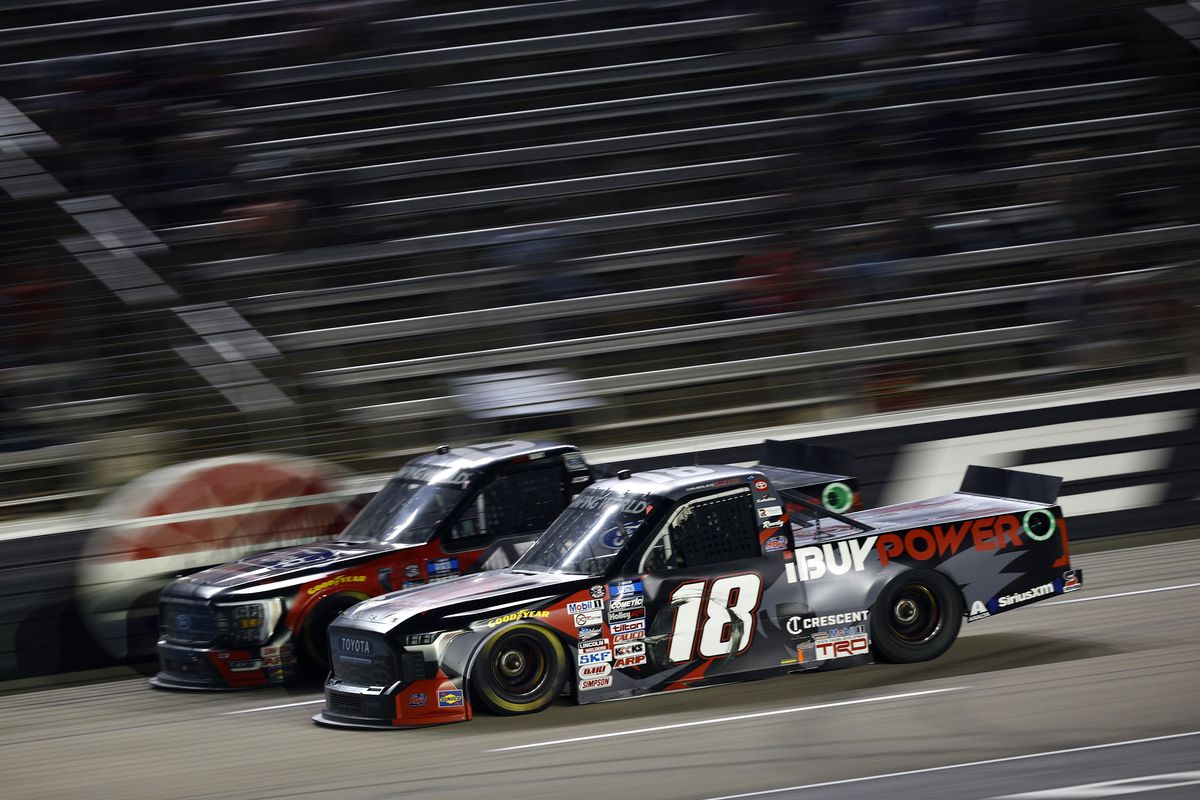Chandler Smith, driver of the #18 iBuyPower Toyota, and Tanner Gray, driver of the #15 Ford Performance Ford, race during the NASCAR Camping World Truck Series SpeedyCash.com 220 at Texas Motor Speedway on May 20, 2022 in Fort Worth, Texas.