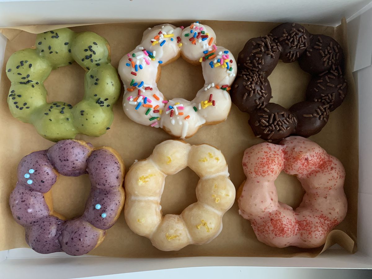 A box of colorful doughnuts.