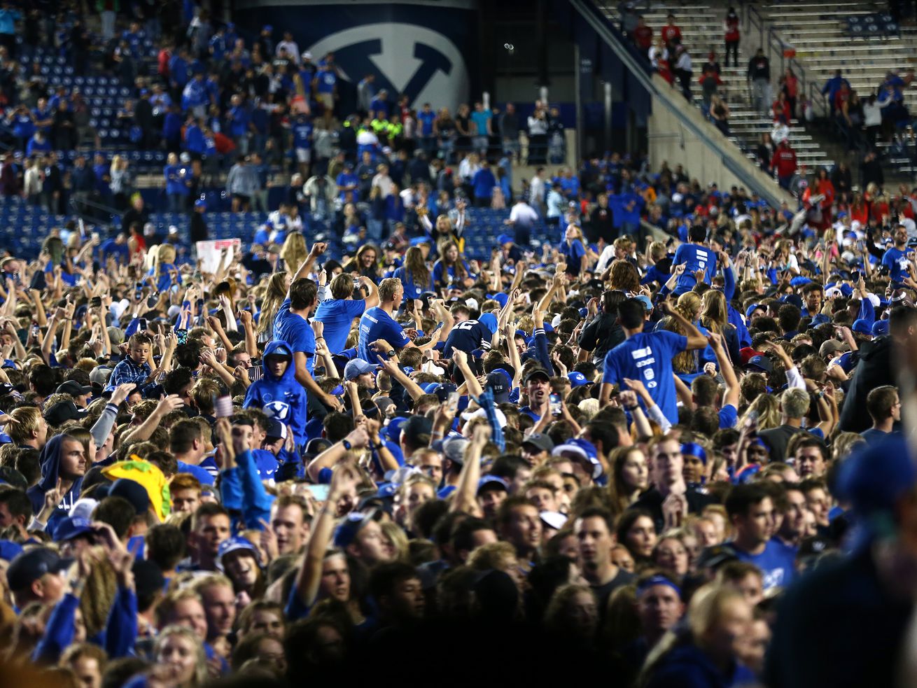 Fans swarm the field after BYU beat Utah in at LaVell Edwards Stadium in Provo on Saturday, Sept. 11, 2021. BYU won 26-17.