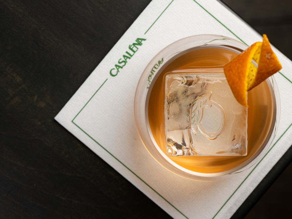 An Old Fashioned on a branded napkin from Casaléna.
