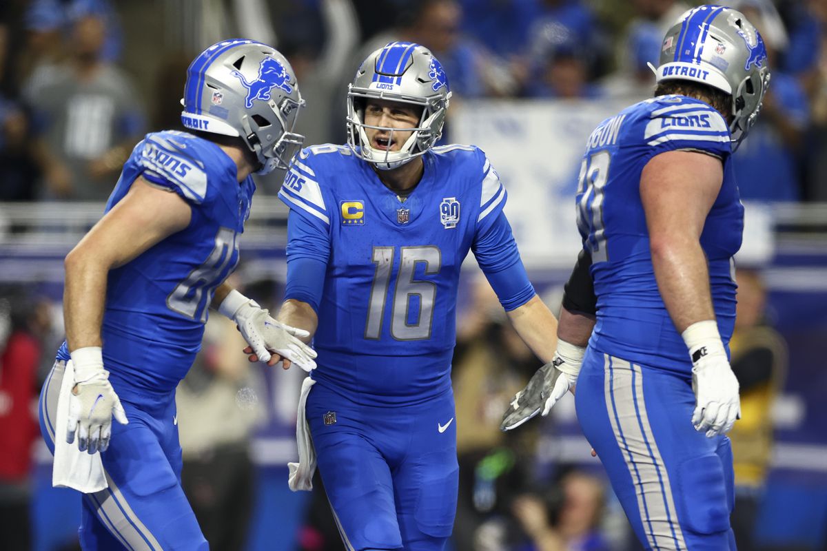 Jared Goff #16 of the Detroit Lions celebrates with Sam LaPorta #87 after a touchdown during an NFL divisional round playoff football game against the Tampa Bay Buccaneers at Ford Field on January 21, 2024 in Detroit, Michigan.