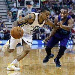 Trey Burke (3) of the Utah Jazz drives against Kemba Walker (15) of the Charlotte Hornets during NBA basketball in Salt Lake City, Monday, March 16, 2015.