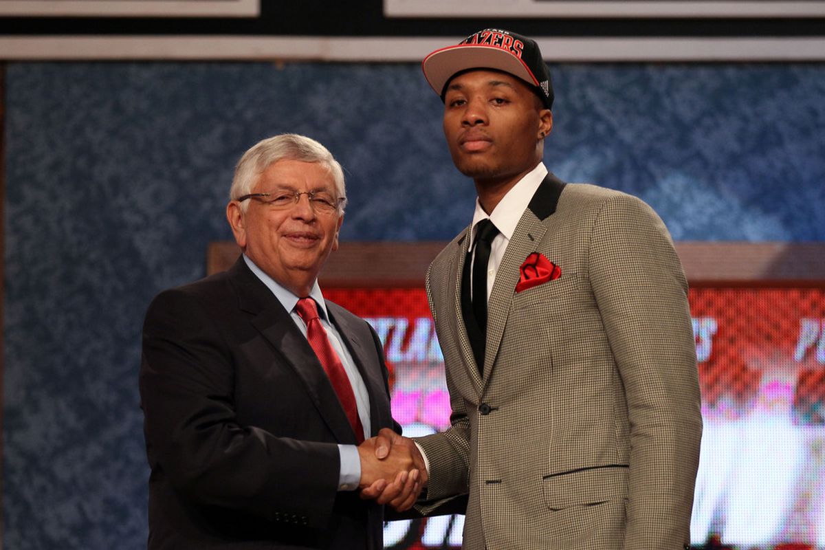 Damian Lillard greets NBA Commissioner David Stern after he was selected number six overall by the Portland Trail Blazers during the first round of the 2012 NBA Draft. Clearly neither man has been taught a proper smile.