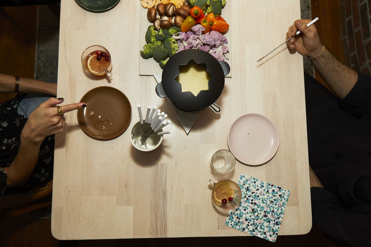 Overhead view of a wooden table with colorful plates. 