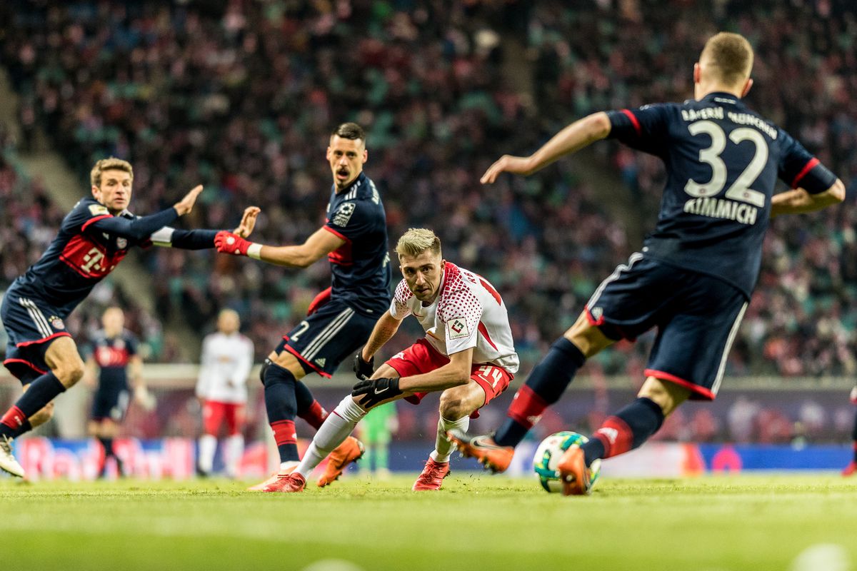 Kevin Kampl of RB Leipzig in action with Joshua Kimmich of FC Bayern Muenchen during the Bundesliga match between RB Leipzig and FC Bayern Muenchen at Red Bull Arena on March 18, 2018 in Leipzig, Germany.