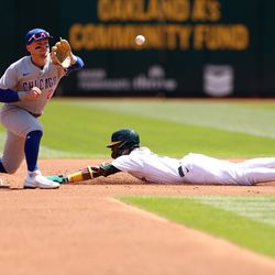 Esteury Ruiz #1 of the Oakland Athletics steals second base while Nico Hoerner #2 of the Chicago Cubs waits for the ball in the first inning at RingCentral Coliseum on April 19, 2023 in Oakland, California.