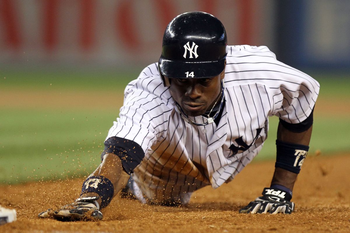 NEW YORK, NY - JUNE 09: Curtis Granderson #14 of the New York Yankees dives safely into first against the Boston Red Sox on June 9, 2011 at Yankee Stadium in the Bronx borough of New York City.  (Photo by Nick Laham/Getty Images)