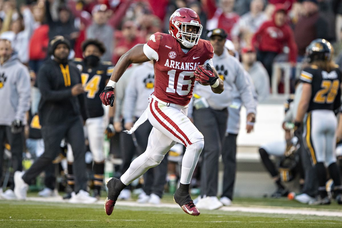 Treylon Burks #16 of the Arkansas Razorbacks catches a pass for a touchdown during a game against the Missouri Tigers at Donald W. Reynolds Razorback Stadium on November 26, 2021 in Fayetteville, Arkansas. The Razorbacks defeated the Tigers 34-17.