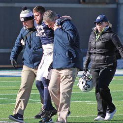 Senior wide reciever Andrew Rodriguez is helped off the field by members of the USU athletic training staff after suffering an injury to his left knee on the first play of Saturday's scrimmage at Maverik Stadium in Logan. 