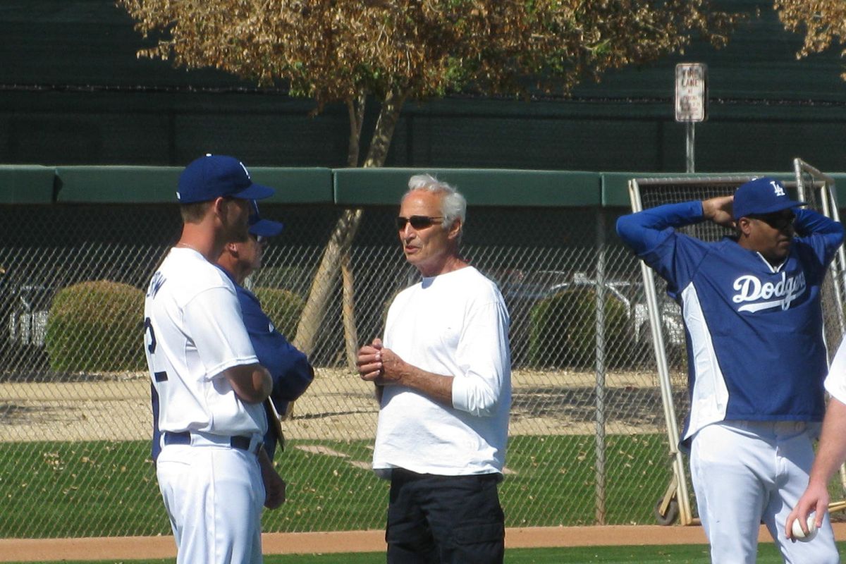 Sandy Koufax talks to a pair of fellow left-handers in Clayton Kershaw and pitching coach Rick Honeycutt on Sunday, his first day at camp.