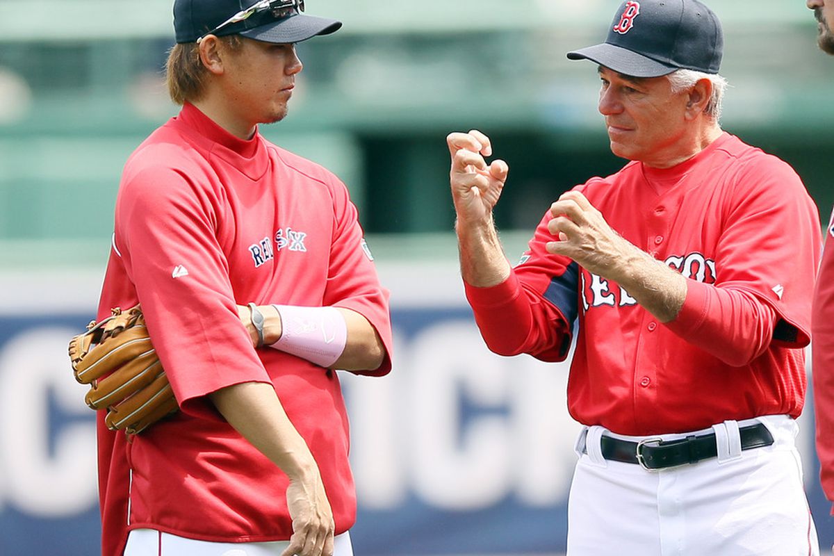 BOSTON, MA - MAY 13:  Manager Bobby Valentine #25 talks with Daisuke Matsuzaka #18 of the Boston Red Sox before the game against the Cleveland Indians at Fenway Park in Boston, Massachusetts.  (Photo by Elsa/Getty Images)