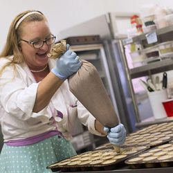 Leslie Fiet, owner of Mini's Gourmet Cupcakes, makes cupcakes at her shop in Salt Lake City on Friday, Feb. 6, 2015. Fiet rescued a kidnapped 3-year-old girl on Wednesday evening, and the shop has been busy with customers since then.