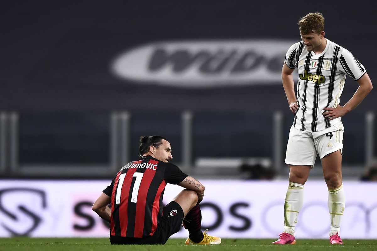 Zlatan Ibrahimovic (L) of AC Milan is seen after suffering a...