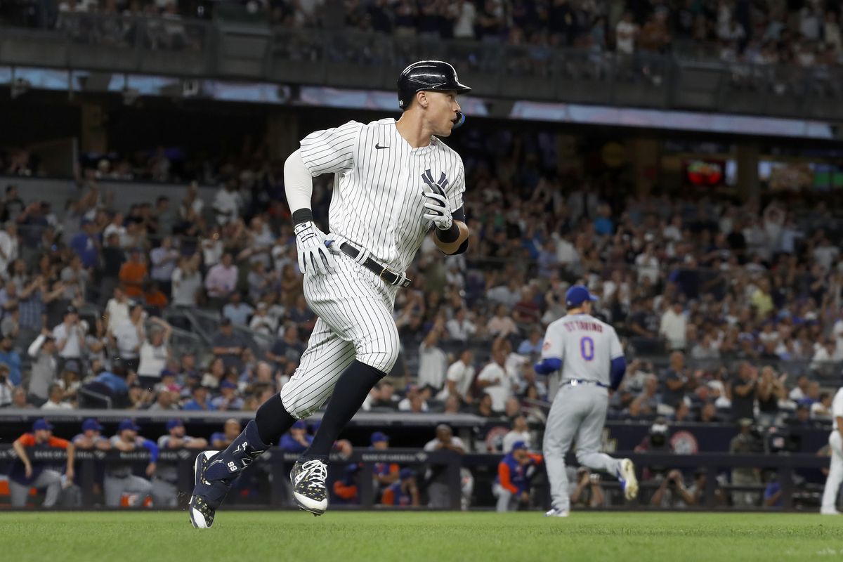 Aaron Judge #99 of the New York Yankees runs out his seventh inning RBI base hit against Adam Ottavino #0 of the New York Mets at Yankee Stadium on August 23, 2022 in New York City.