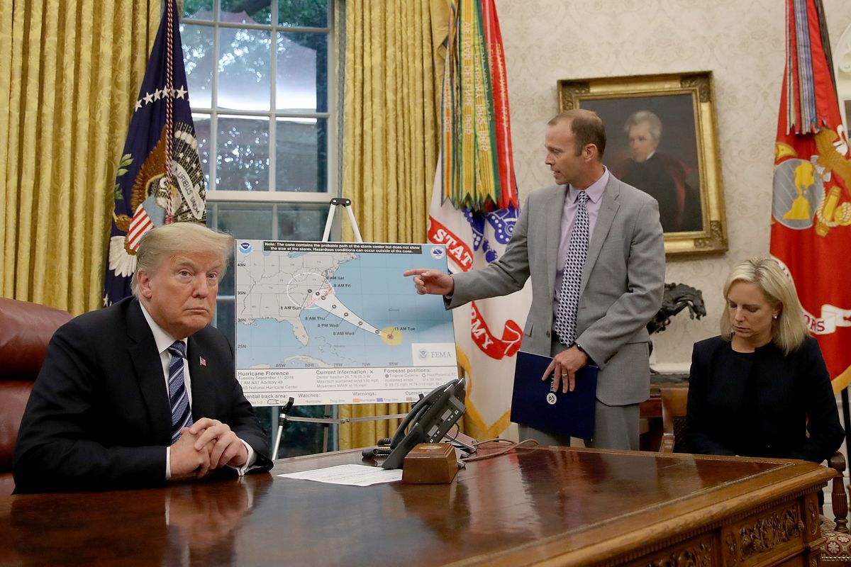 President Donald Trump listens to FEMA administrator Brock Long describe Hurricane Florence’s path toward Virginia and the Carolinas at the White House on September 11, 2018.