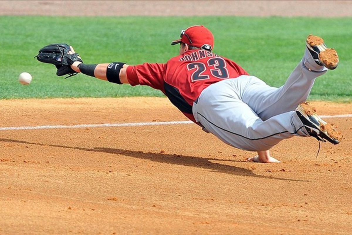 March 08, 2012; Melbourne, FL, USA;   Houston Astros third baseman Chris Johnson (23) dives for a ground ball during the spring training game against the Washington Nationals  at Space Coast Stadium. Mandatory Credit: Brad Barr-US PRESSWIRE