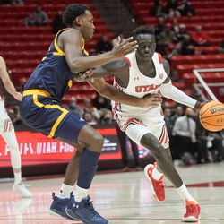 Utah guard Both Gach, right, goes past California guard Jalen Celestine during an NCAA game at the Huntsman Center in Salt Lake City on Sunday, Dec. 5, 2021.