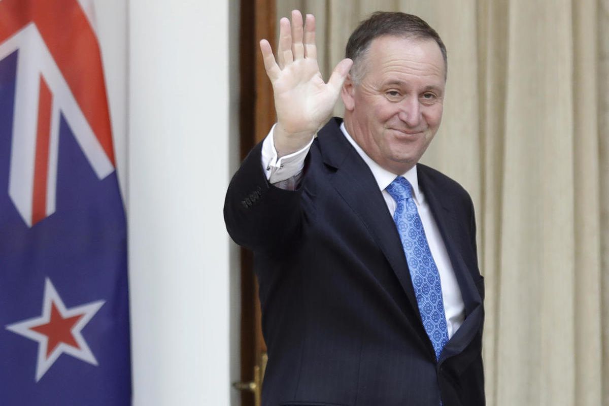 FILE - In this Oct. 26, 2016 file photo, New Zealand's Prime Minister John Key waves to media before his meeting with Indian counterpart Narendra Modi in New Delhi, India. John Key stunned the nation on Monday, Dec. 5 when he announced he was resigning af