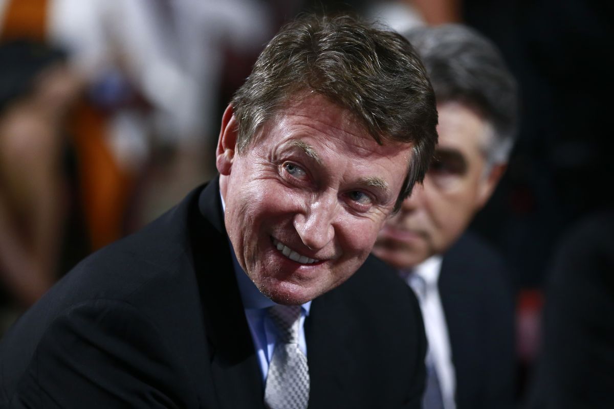 Former NHL player Wayne Gretzky of the Edmonton Oilers looks on from the draft table during the first round of the 2019 NHL Draft at Rogers Arena on June 21, 2019 in Vancouver, Canada.