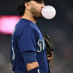 ANAHEIM, CA - AUGUST 16: Seattle Mariners third baseman Eugenio Suarez (28) blows a bubble during the MLB game between the Seattle Mariners and the Los Angeles Angels of Anaheim on August 16, 2022 at Angel Stadium of Anaheim in Anaheim, CA.