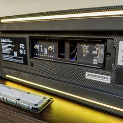 <em>On the bottom, an extra-long 110mm PCIe NVMe Gen 4 drive slot, and a button to turn off the LED lighting.</em>