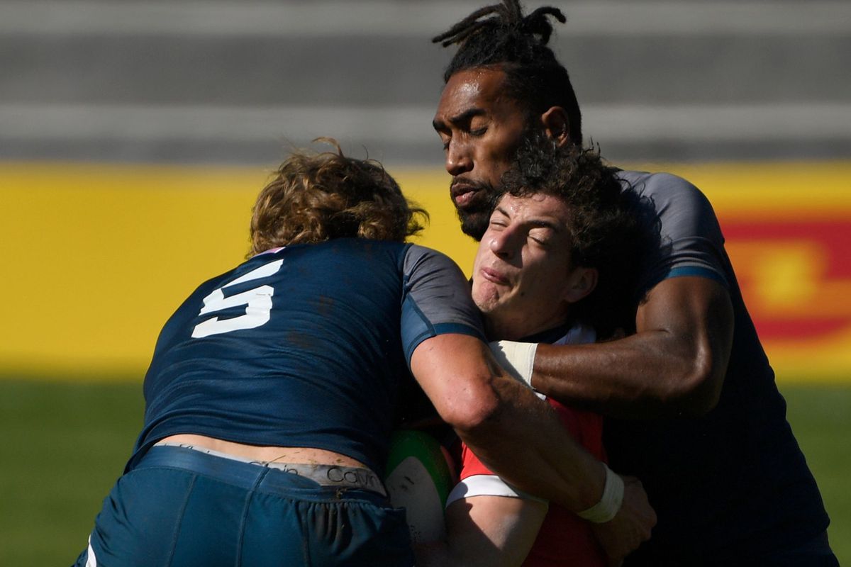 USA Rugby 7 team’s Joseph Schroeder and Mataiaysi Leuta vie with Chile Rugby 7 team’s Nicolas Navarrete during the Madrid Rugby 7s International Tournament at the Complutense University stadium in Madrid on February 27, 2021.
