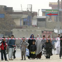 Afghans gather near the Shiite Baqir-ul Ulom mosque after a suicide attack inside it, in Kabul, Afghanistan, Monday, Nov. 21, 2016. An Afghan official says that dozens of civilians have been killed after a suicide bomber attacked a Shiite mosque in the capital. 