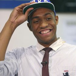 Simeon Career Academy's Jabari Parker smiles as he puts on a Duke University cap after announcing he will be attending Duke during a news conference at his high school on Thursday, Dec. 20, 2012, in Chicago. (AP Photo/Charles Rex Arbogast)