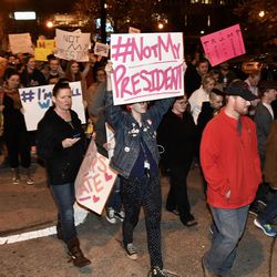 Protesters holds up signs in opposition of Donald Trump's presidential election victory as they march from Jefferson Square Park, Thursday, Nov. 10, 2016 in Louisville Ky. 