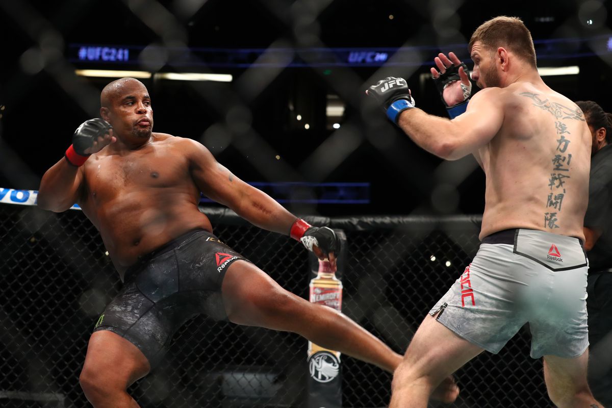 Daniel Cormier kicks Stipe Miocic in the first round during their UFC Heavyweight Title Bout at UFC 241 at Honda Center on August 17, 2019 in Anaheim, California.