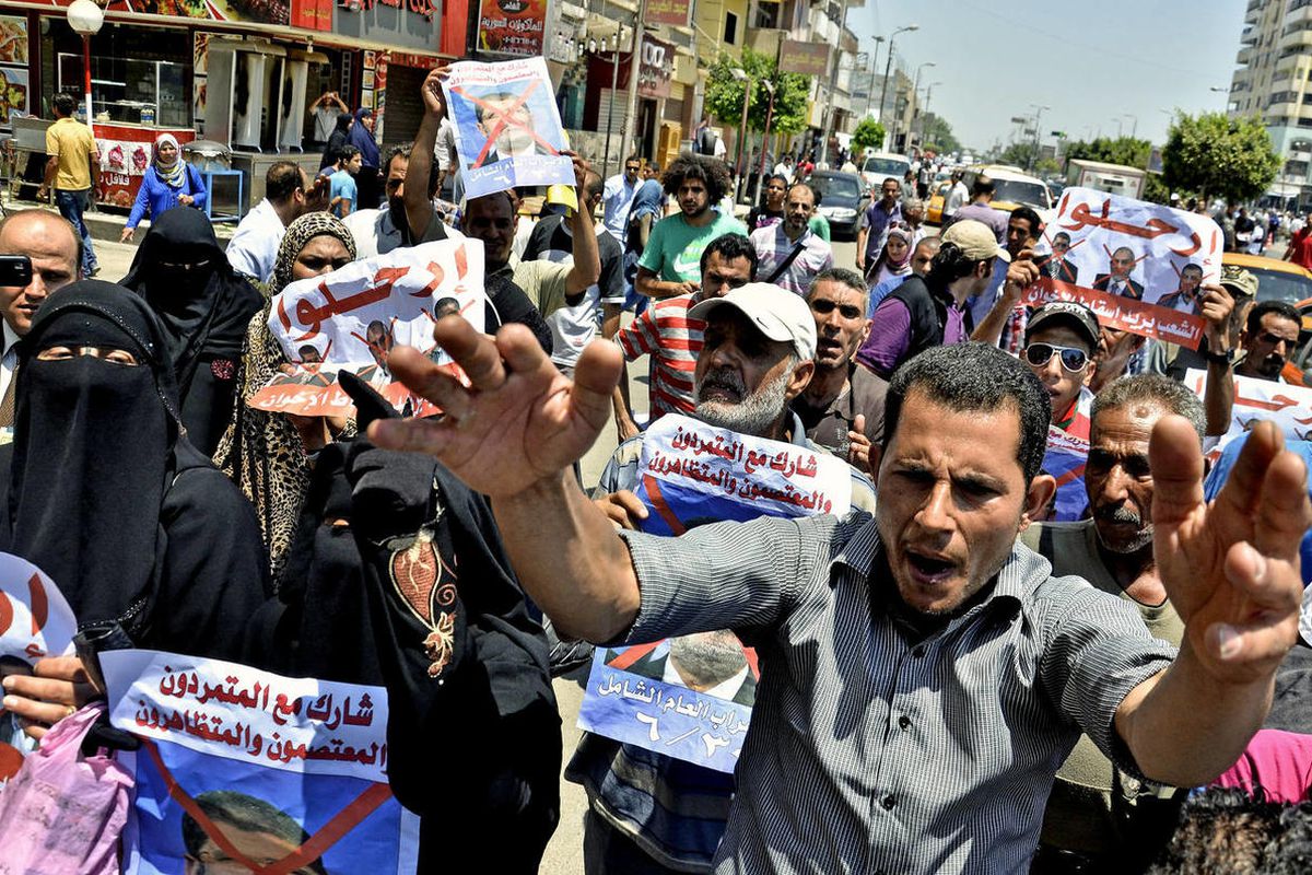 Protesters chant slogans against Egyptian President Mohammed Morsi outside a court in Ismailia, 139 Kilometers (86 miles) from Cairo, Egypt, Sunday, June 23, 2013. An Egyptian court on Sunday said Muslim Brotherhood members conspired with Hamas, Hezbollah
