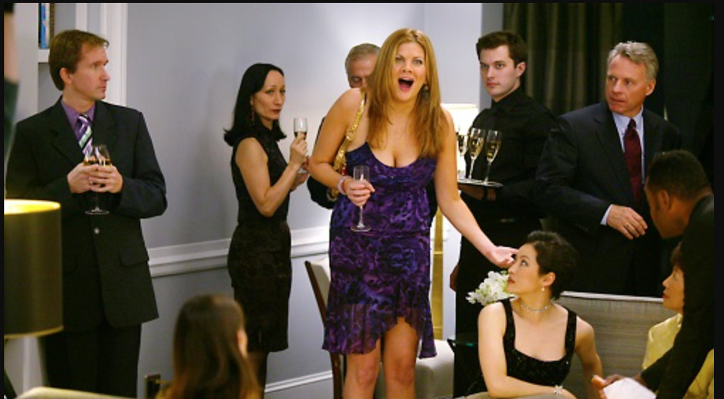 A woman at a cocktail party laughing loudly while everyone looks at her.
