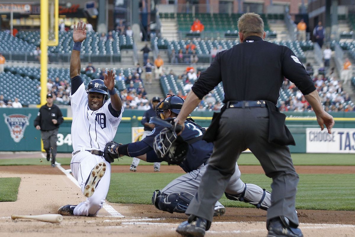 DETROIT - APRIL 26: Austin Jackson #14 of the Detroit Tigers is tagged out at home by Miguel Olivo #30 of the Seattle Mariners in the first inning at Comerica Park on April 26, 2011 in Detroit, Michigan.  (Photo by Leon Halip/Getty Images)
