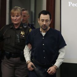 Dr. Larry Nassar is escorted into court during the seventh day of his sentencing hearing Wednesday, Jan. 24, 2018, in Lansing, Mich. Nassar has admitted sexually assaulting athletes when he was employed by Michigan State University and USA Gymnastics, which is the sport's national governing organization and trains Olympians. (AP Photo/Carlos Osorio)