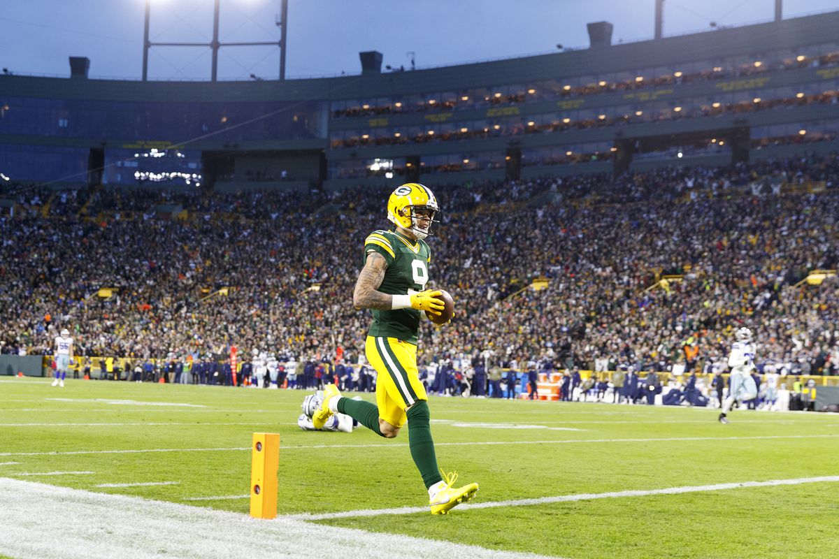 Green Bay Packers wide receiver Christian Watson (9) scores a touchdown after catching a pass during the second quarter against the Dallas Cowboys at Lambeau Field.&nbsp;