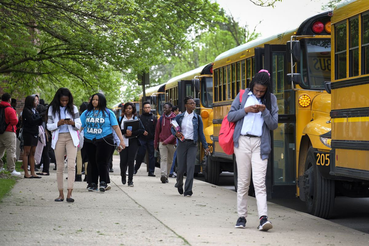 Students leave buses, on their way to classes at Providence Cristo Rey High School, a private, Roman Catholic high school in Indianapolis, Indiana. — May, 2019 — Photo by Alan Petersime/Chalkbeat