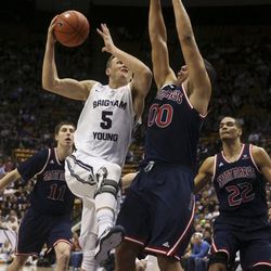 BYU guard Kyle Collinsworth (5) goes up for a basket while being guarded by St. Mary's forward Brad Waldow (0) during an NCAA college basketball game, Thursday, Feb. 12, 2015 in Provo, Utah. 