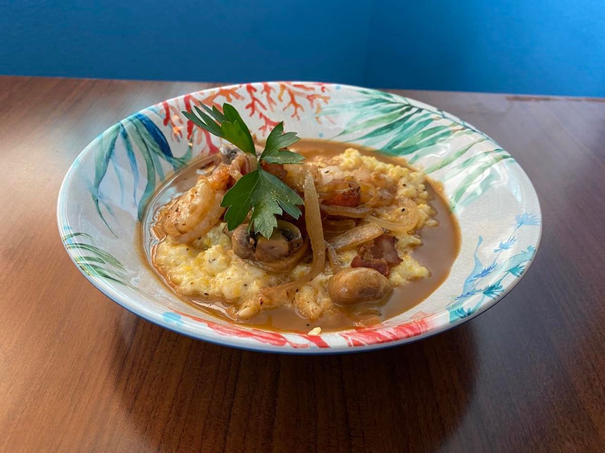 Low Tide Kitchen &amp; Bar’s shrimp and grits, with Gulf shrimp, grits, onions, mushrooms, and bacon,.