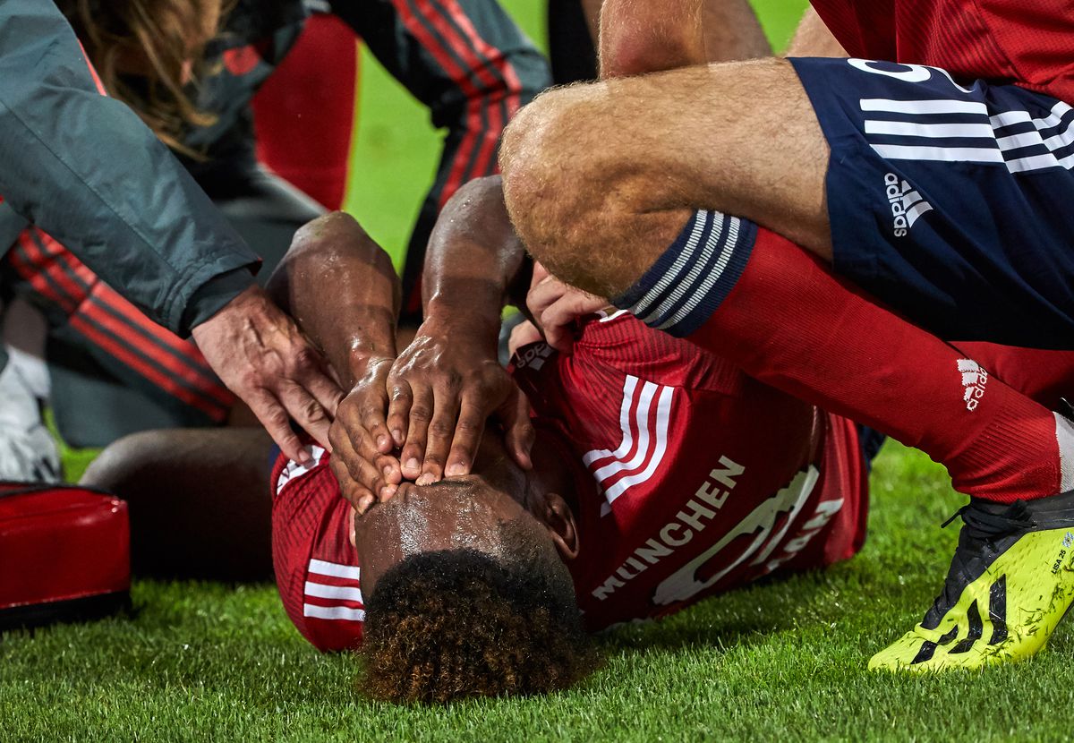 MUNICH, GERMANY - AUGUST 24: Kingsley Coman of Bayern Muenchen lays injured on the ground during the Bundesliga match between FC Bayern Muenchen and TSG 1899 Hoffenheim at Allianz Arena on August 24, 2018 in Munich, Germany. 