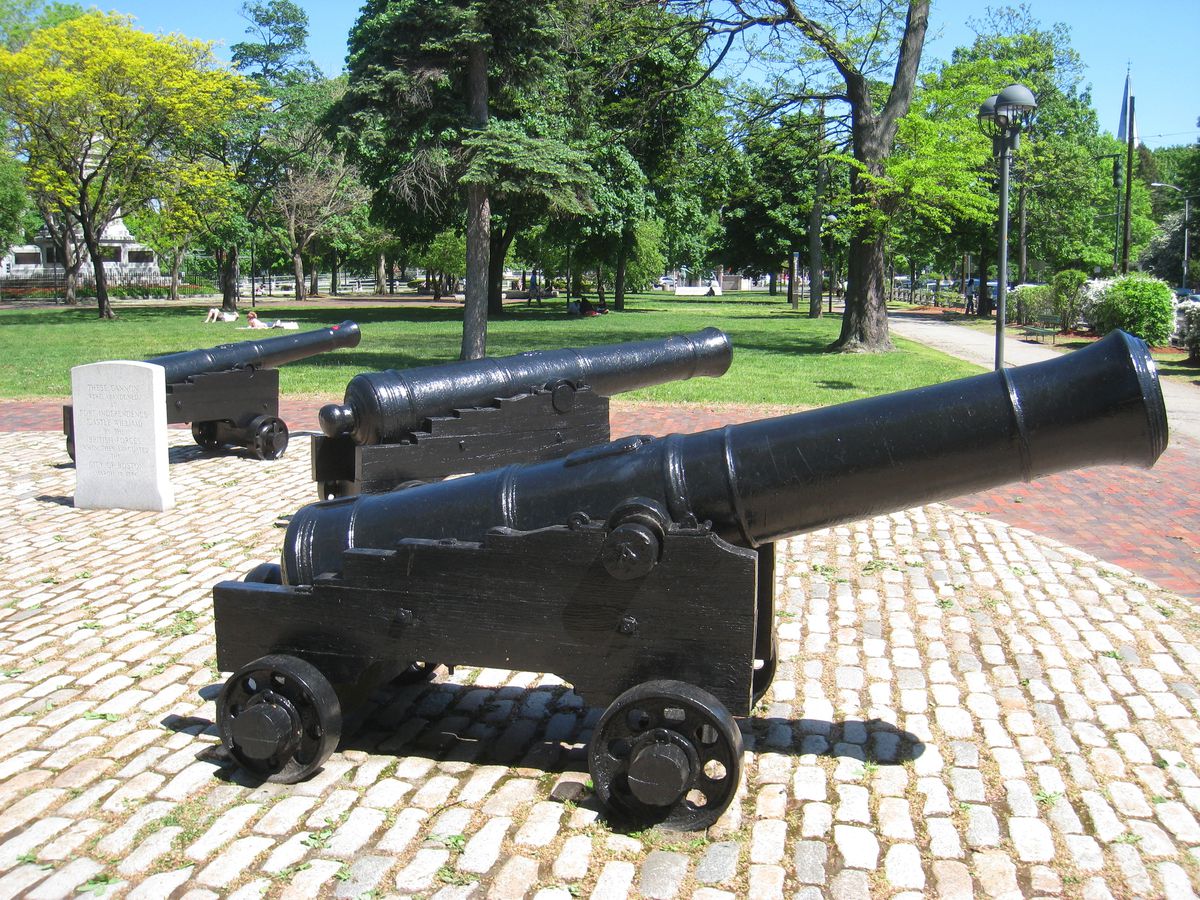 Three vintage cannons arrayed in a public park.
