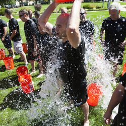 Officer Jeremy Barnes dumps a bucket of water on himself during the the Utah Law Enforcement Memorial Ice Water Challenge at Draper Historic Park, Wednesday, Sept. 3, 2014. One bucket of ice water was dumped on an officer's head for each of the 137 officers who have been killed in the line of duty in Utah.