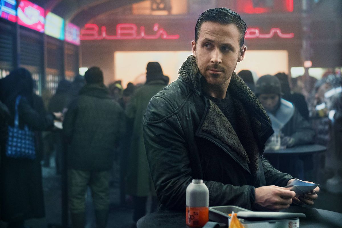 Ryan Gosling looks across a crowded room in Blade Runner 2049