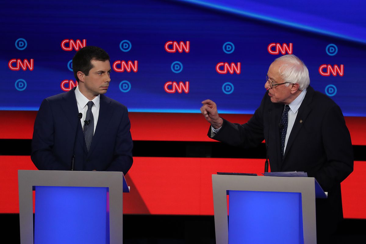 Democratic presidential candidate Sen. Bernie Sanders (I-VT) (R) speaks while South Bend, Indiana Mayor Pete Buttigieg listens during the Democratic Presidential Debate at the Fox Theatre July 30, 2019 in Detroit, Michigan.